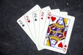 Five playing card`s a hand of a four of a kind two`s and a queen