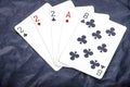 Five playing card`s a hand of a three of a kind two`s and a ace and a eight