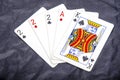 Five playing card`s a hand of a three of a kind two`s and a ace and a king