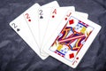 Five playing card`s a hand of a three of a kind two`s and a ace and a jack