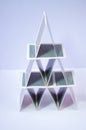 Playing card pyramid made with poker cards on a white background