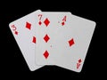 Playing cards 3, 7 and ace are fanned out, isolated on a black background