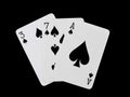 Playing cards 3, 7 and ace are fanned out, isolated on a black background