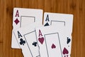 Playing cards aces card close up, isolated on wooden table. Casino concept, risk, chance, good luck or gambling Royalty Free Stock Photo