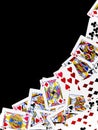 Playing cards are arranged obliquely in a black background. Royalty Free Stock Photo