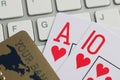 Playing cards bank credit card and computer keyboard on table. Royalty Free Stock Photo