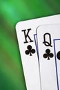 Playing cards, on a blur green background. King and Queen of Clubs. Gambling Royalty Free Stock Photo