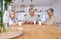 Playing cards, bonding and senior friends with coffee to relax in retirement with a game in a home. Talking, together Royalty Free Stock Photo