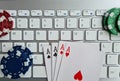 Playing cards and casino chips on computer keyboard Royalty Free Stock Photo