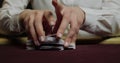 Cards and chips on the table in a casino. Close-up of hands.. Close-up of hands playing poker with chips on red table. Royalty Free Stock Photo