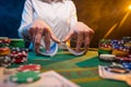 Playing cards in a casino. A lot of chips, money. A player in a casino makes bets. Poker Royalty Free Stock Photo