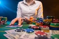 Playing cards in a casino. A lot of chips, money. A player in a casino makes bets. Poker Royalty Free Stock Photo