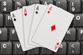 Playing cards on computer keyboard Royalty Free Stock Photo