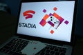 Playing cards and computer screen with the Google Stadia Royalty Free Stock Photo