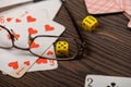 Playing cards  dice and glasses on a wooden table Royalty Free Stock Photo