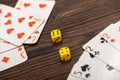 Playing cards and dice on a wooden table Royalty Free Stock Photo