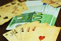 Playing cards and euro money on the table Royalty Free Stock Photo