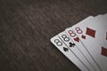 Playing cards four eights closeup on a wooden table.