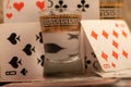 Playing cards and a glass of vodka on a table covered with coarse burlap Royalty Free Stock Photo
