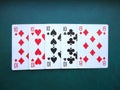 Playing cards on green background