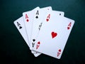 Playing cards on green background. Set of four aces.