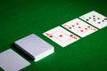 Playing cards on green table surface Royalty Free Stock Photo