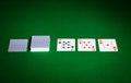 Playing cards on green table surface Royalty Free Stock Photo