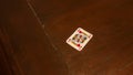 playing cards like poker or rummy, red king of hearts, alone on a dark brown wooden game table Royalty Free Stock Photo