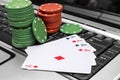 Playing cards with poker chips on laptop keyboard. Online casino Royalty Free Stock Photo