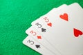 Playing cards, poker combination four of kind, quads, threes of different suits, same value Royalty Free Stock Photo