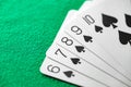 Playing cards, poker combination straight flush of black suit of spades from ten Royalty Free Stock Photo