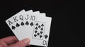 Playing cards poker hands on a black