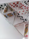 Playing cards pyramid on a white background Royalty Free Stock Photo