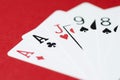 Playing cards on red background close-up, soft focus