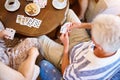 Playing the cards theyre dealt. High angle shot of a group of seniors playing cards around a table in their retirement Royalty Free Stock Photo