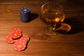 Playing cards and wine glass of cognac on wood table Royalty Free Stock Photo