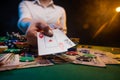 Playing in a casino, online casino. A player opens cards with two aces. Money, poker table, chips. Background for the gaming Royalty Free Stock Photo