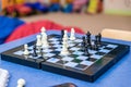 chessboard side view, hand moving a chess piece, about to grab it, closeup. Making a move, strategy, planning, challenge and