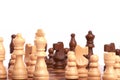 Playing a chess game or a battle. White and black wooden pieces on the board and planning a common team strategy, Isolated on Royalty Free Stock Photo