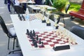 Playing chess outdoors in the park. The table with game of chess stands in the open air Royalty Free Stock Photo