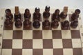 Playing chess in tournament. Chess pieces on board. Sports competition at school. Gaming prowess