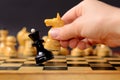 Playing chess. White knight Hitting the black queen in front of the rest figures Royalty Free Stock Photo