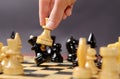 Playing chess. White queen Hitting the black one in front of the rest figures Royalty Free Stock Photo