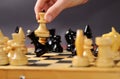 Playing chess. White queen Hitting the black one in front of the rest figures Royalty Free Stock Photo