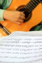 Playing classical guitar with music score