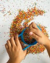 Playing with the colourful sugar sprinkles. Fun activities for children. Fine motor skills