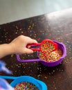 Playing with the colourful sugar sprinkles. Fun activities for children. Fine motor skills