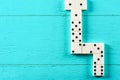 Playing dominoes on a blue wooden table Royalty Free Stock Photo