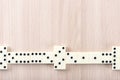 Playing dominoes on a wooden table Royalty Free Stock Photo