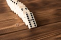 Playing dominoes on a wooden table. Domino effect Royalty Free Stock Photo